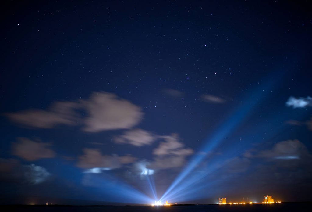 The United Launch Alliance Atlas V rocket with NASA's Origins, Spectral Interpretation, Resource Identification, Security-Regolith Explorer (OSIRIS-REx) spacecraft on board is seen illuminated in the distance in this thirty second exposure on Wednesday, Sept. 7, 2016 at Cape Canaveral Air Force Station in Florida. OSIRIS-REx is scheduled to launch on Sept. 8 from and will be the first U.S. mission to sample an asteroid, retrieve at least two ounces of surface material and return it to Earth for study. The asteroid, Bennu, may hold clues to the origin of the solar system and the source of water and organic molecules found on Earth. Photo Credit: (NASA/Joel Kowsky)